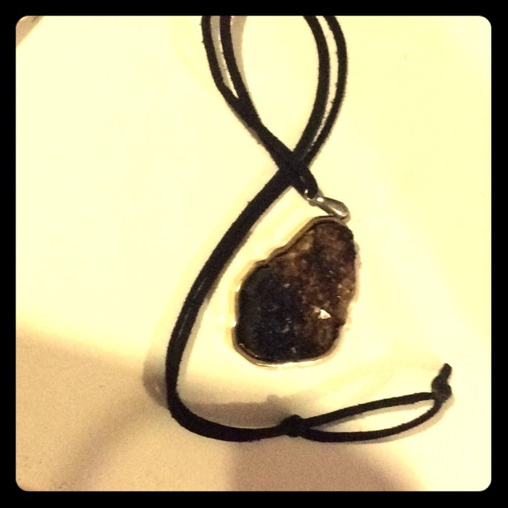 stone necklace with black string and gold setting